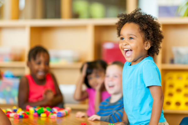 children in preschool happily playing