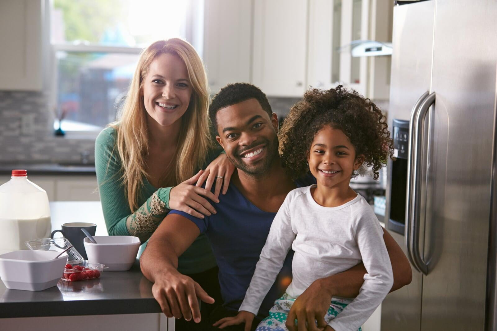 family sitting in kitchen 